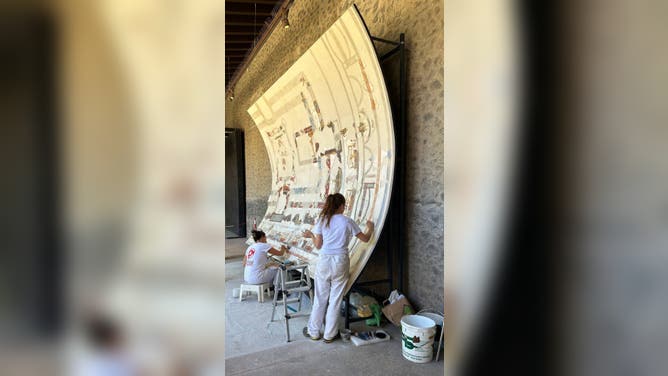 People work to restore the fresco in Pompeii, Italy.