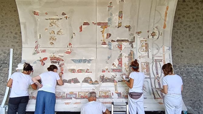 Officials work to restore fresco.
