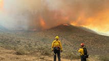 Crews work to contain human-caused Hawk Fire that has destroyed dozens of homes, forced thousands to evacuate