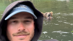 Video: Fisherman and grizzly bear share Alaskan river while hunting for salmon