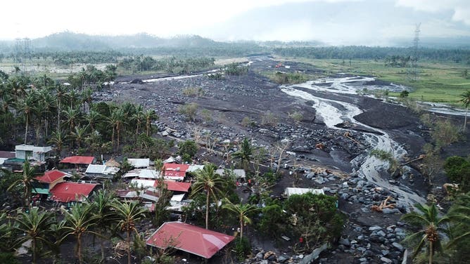 This aerial photo taken on November 2, 2020, shows houses buried by boulders and lahar washed from the slopes of nearby Mayon Volcano in Guinobatan town, Albay province, south of Manila, after super Typhoon Goni made landfall in the Philippines on November 1.