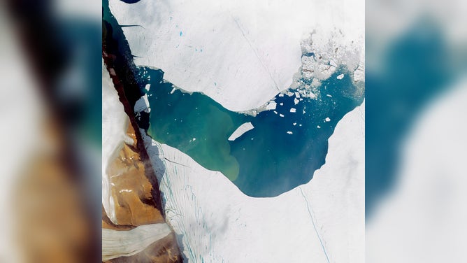 PETERMANN GLACIER, GREENLAND - JULY 19, 2012: This is a satellite image of a massive iceberg calving from the Petermann Glacier in Greenland, collected on July 19, 2012.