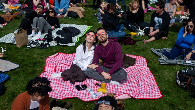 BROOKLYN, NEW YORK, UNITED STATES - 2024/04/08: People gather at Greenwood Cemetery in Brooklyn to witness a partial solar eclipse. Thousands gathered in parks and open spaces across the city to view up to 90% of the sun covered by the moon.