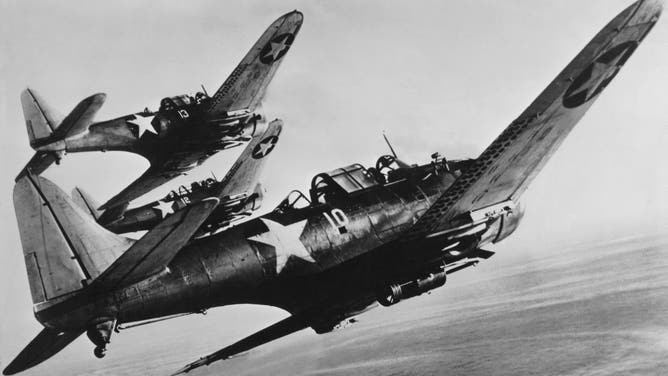 United States Navy carrier based Douglas SBD-3 Dauntless single engine scout plane dive bombers flying in formation over the Pacific during the Battle of Midway campaign circa June 1942 in the Hawaiian Islands archipelago of the North Pacific Ocean.