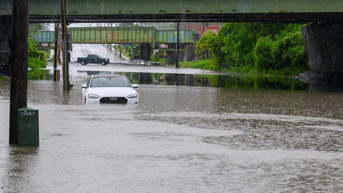 ALBANY, NY - JUNE 7: A white Audi got stuck when Central Avenue flooded under the I-90 overpass on Saturday, June 7, 2025, in Albany, NY.