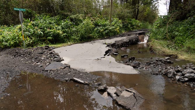 A road damaged by Hurricane Lala is seen in Mountain View, Hawaii, on August 16, 2026. Hurricane Lala was pulling away from Hawaii's Big Island early Sunday, as heavy rain and strong winds struck the US Pacific state and officials warned of potentially dangerous flooding. The heavy rain and flood risk will then spread westward across the island chain on Sunday, according to the NHC.