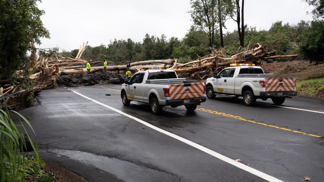 Hawaii Department of Transportation workers inspect road damage caused by Hurricane Lala in Pahala, Hawaii, on August 16, 2026. Hurricane Lala was pulling away from Hawaii's Big Island early Sunday, as heavy rain and strong winds struck the US Pacific state and officials warned of potentially dangerous flooding. The heavy rain and flood risk will then spread westward across the island chain on Sunday, according to the NHC.