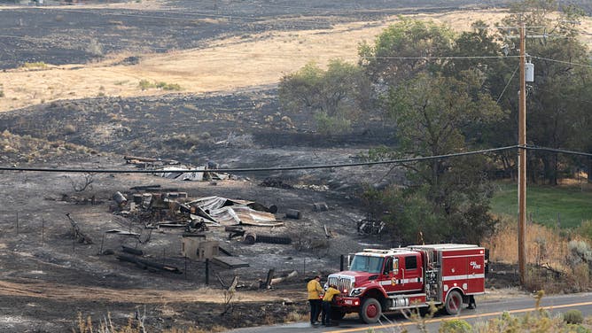 RENO, NEVADA - AUGUST 23: Firefighters pack their truck after responding to a burned building during the Hawk Fire on August 23, 2026 in Reno, Nevada.