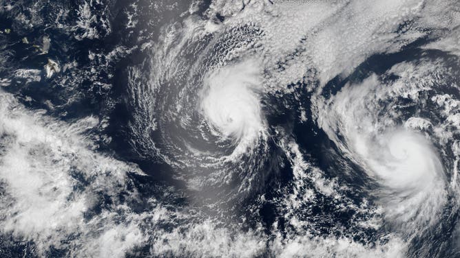 PACIFIC OCEAN - AUGUST, 2014: In this composite image provided by NASA, Hurricane Iselle (L) is followed by Hurricane Julio as they approach Hawaii from the east in early August, 2014. Hurricane Iselle is exppected to make landfall on August 7th, making it Hawaii's first hurricane in 22 years. This image is a composite of three satellite passes over the tropical Pacific Ocean of August 5th.