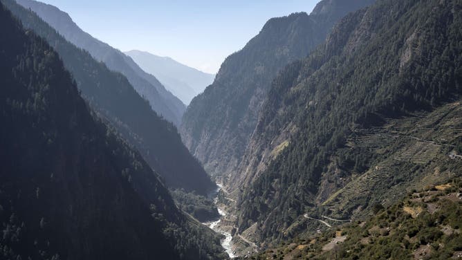 UTTARAKHAND, INDIA - 2016/10/16: The valley of the Ganges River, one of the world's longest river, winds through rice fields in Western Himalayas. The river which rises in the Indian state of Uttarakhand, not far from the Chinese border, flows on 2,525 km to the south and enters Bangladesh where it empties into the Bay of Bengal in the Indian Ocean.