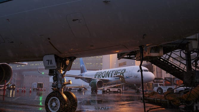Frontier Airlines Inc. planes sit in the rain on the tarmac at Denver International Airport (DIA) in Denver, Colorado, U.S., on Tuesday, April 4, 2017. Frontier Airlines Inc., the no-frills U.S. carrier whose aircraft feature animals on the tails, is aiming to go public as soon as the second quarter, people with knowledge of the matter said.