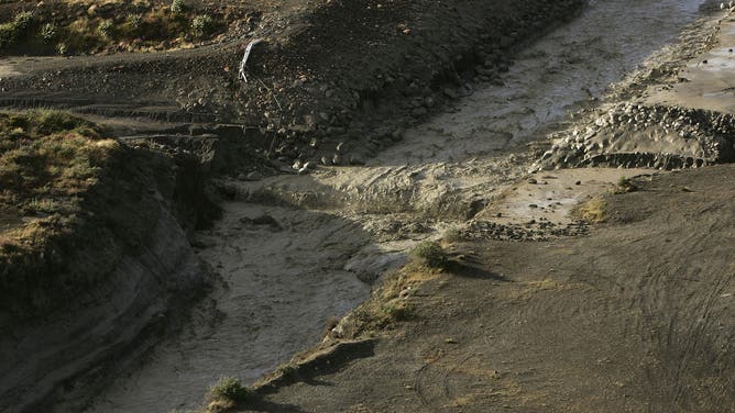 WANGANUI, NEW ZEALAND - MARCH 18: A road has been washed away as the Lahar makes its way along the path of the Whangaehu River after breaking the crater wall on Mount Ruapehu on March 18, 2007 in the National Park, New Zealand. The lake levels rose, causing the crater rim to collapse to send the mudflow (Lahar) down the mountain.