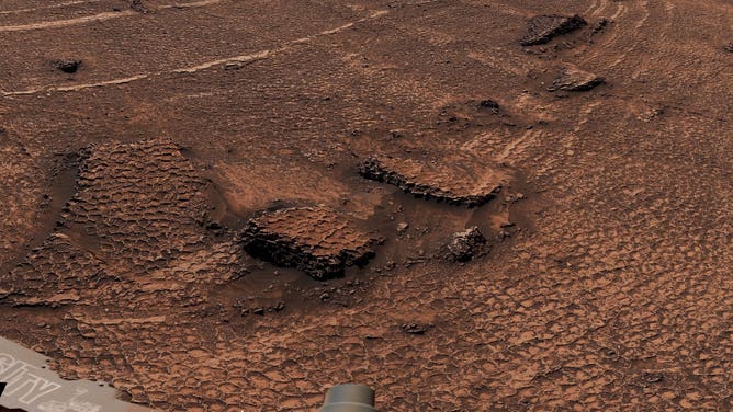 Honeycomb textures across the dry landscape on Mars.