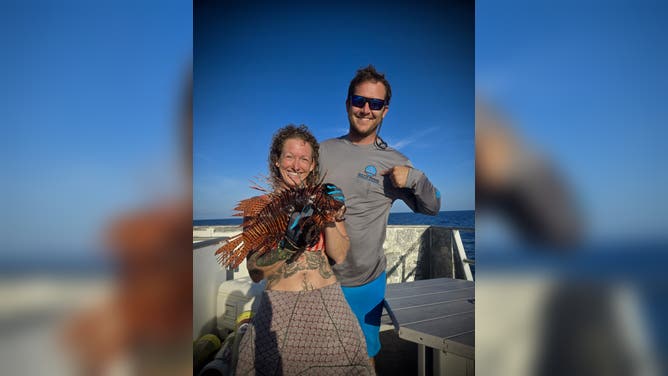 Rachel Bowman and a colleague holding a lionfish after one of the Lionfish Invitational diving expeditions.