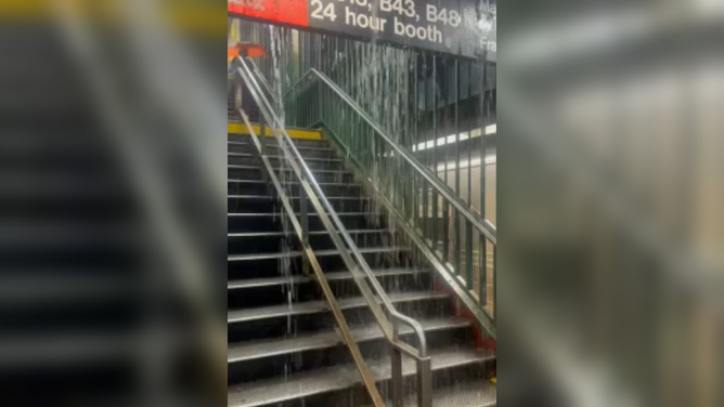 Floodwaters pour into New York City Subway station.