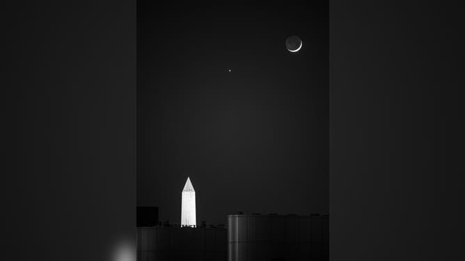 The Moon and Venus, center, are seen in conjunction above the Washington Monument, Monday, May 18, 2026, as viewed from the Mary W. Jackson NASA Headquarters Building in