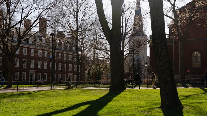 CAMBRIDGE, MASSACHUSETTS - APRIL 17: People walk through campus at Harvard University on April 17, 2025 in Cambridge, Massachusetts.
