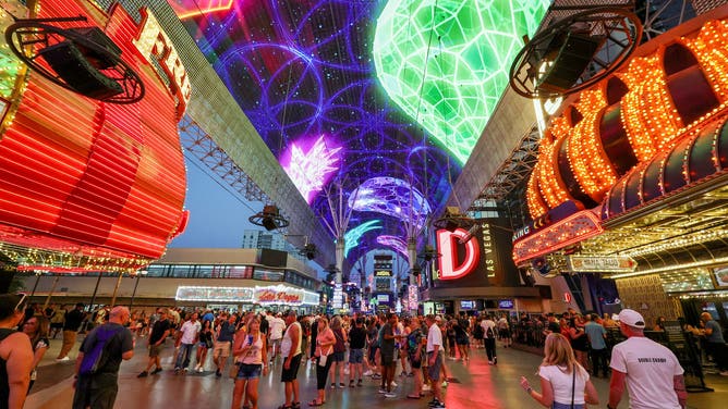 LAS VEGAS, NEVADA - AUGUST 30: People walk under the Fremont Street Experience attraction's Viva Vision canopy screen on August 30, 2025 in downtown Las Vegas, Nevada.