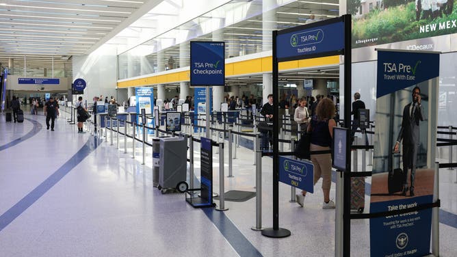 TSA PreCheck signage is displayed at the entrance to a Transportation Security Administration (TSA) checkpoint at Los Angeles International Airport (LAX) in Los Angeles on March 23, 2026.