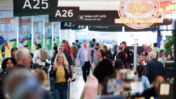 HOUSTON, TEXAS - JUNE 9: People make their way through Terminal A at George Bush Intercontinental Airport ahead of the FIFA World Cup in Houston, Tuesday, June 9, 2026.