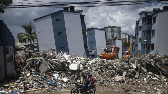 A motorcycle rides past a collapsed building after the 7.4-magnitude earthquake in Pereira, Risaralda department, Colombia, on August 23, 2026.