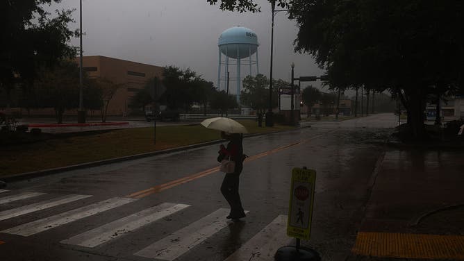 BEAUMONT, TEXAS - SEPTEMBER 1: A medical worker walks towards CHRISTUS Southeast Texas St.Elizabeth hospital during Tropical Storm Edouard on September 1, 2026 in Beaumont, Texas.