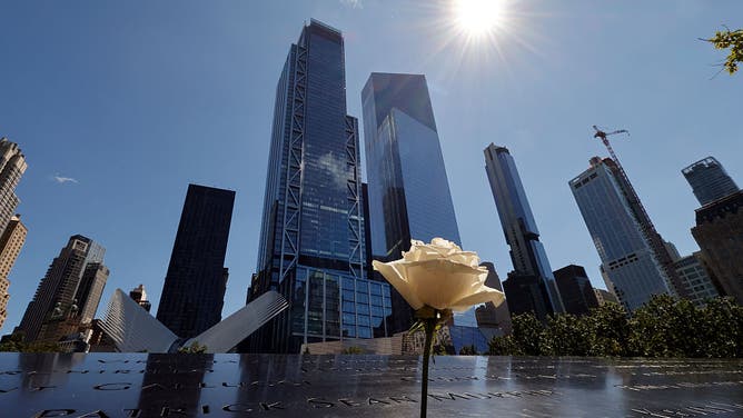 NEW YORK, NY - SEPTEMBER 7: A rose stands on the 9/11 Memorial for the North Tower in front of 3 and 4 World Trade Center on September 7, 2026, in New York City.