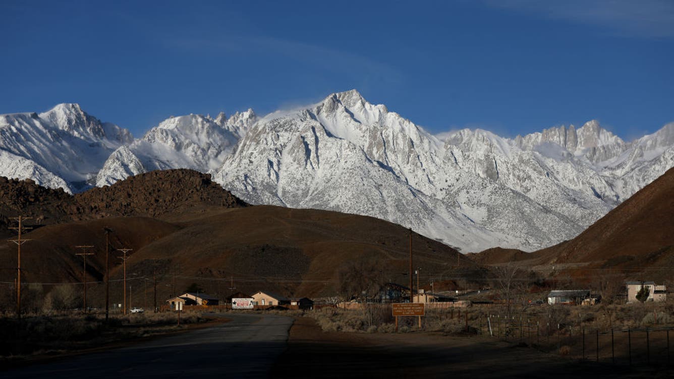 LONE PINE, CA - MARCH 22: Lone Pine Peak, center, elevation 12,949 feet, and Mount Whitney, far right, the highest mountain in the contiguous United States and the Sierra Nevada, with an elevation of 14,505 feet, are located on the east side of the Sierra Nevada mountain range, shown from Whitney Portal Road, on Wednesday, March 22, 2023 in Lone Pine, CA.