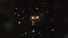 A giant smiley face in space? Hubble captures remarkable galaxy cluster