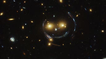 NASA's Hubble captures giant 'smiley face' galaxy cluster in space - Fox News