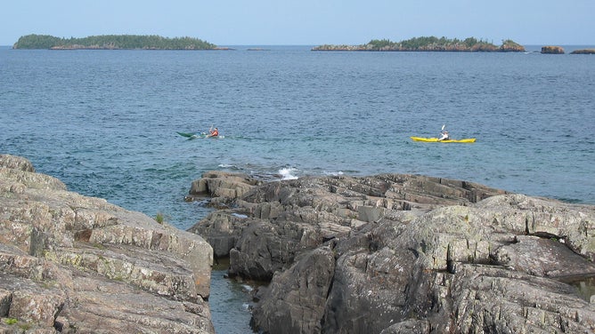 People kayaking in the waters around Isle Royale National Park.