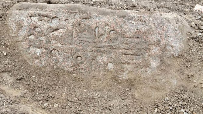 A pink granite block was found about 3 feet from the statues and has hieroglyphic inscriptions.