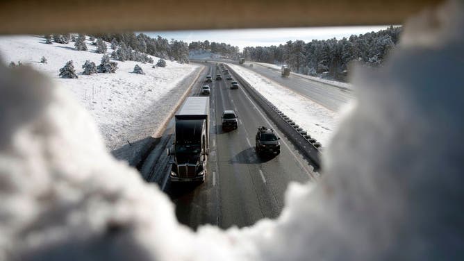 Thanksgiving holiday traffic travels westbound on I- 70 in Genesee, Colorado on November 27, 2019. - A pair of storms packing heavy snow and hurricane-force winds left tens of thousands without power in the United States on November 27, 2019, and wreaked havoc for Americans traveling for the Thanksgiving holiday.