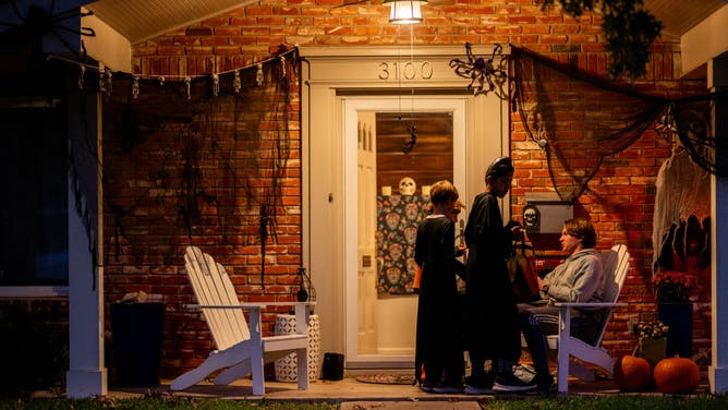 AUSTIN, TEXAS - OCTOBER 31: Community members Trick-or-Treat together in the Allandale neighborhood on October 31, 2023 in Austin, Texas.