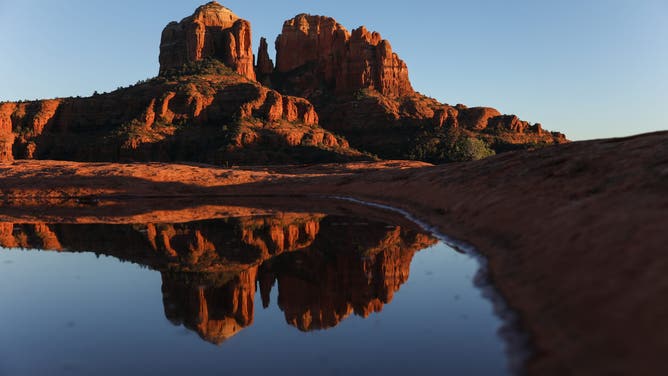 SEDONA, ARIZONA, UNITED STATES - 2025/12/06: Cathedral Rock is seen at sunset from secret Slickrock, Red Rock state park, Sedona.