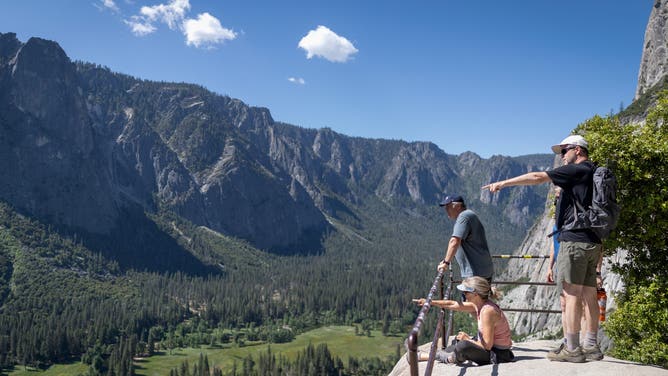 Yosemite, CA, - May 16, 2026: People sit at Columbia Rock on the Upper Yosemite Falls trail in Yosemite National Park on Saturday, May 16, 2026 in Yosemite, CA.