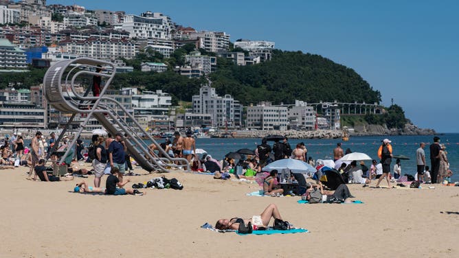 A woman relaxes at Haeundae Beach in Busan, South Korea, on June 28, 2026.