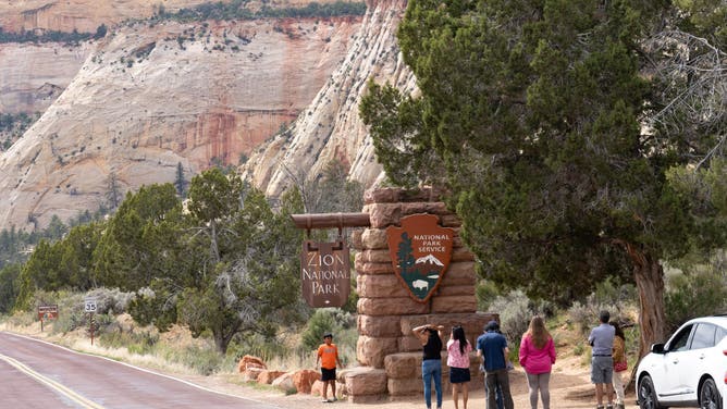 Visitors at entrance to Zion National Park, Utah.