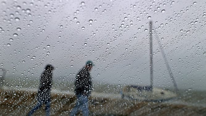 Quincy, MA - September 28: A beached sailboat is viewed through a rainy car window at Wollaston Beach on September 28, 2026.
