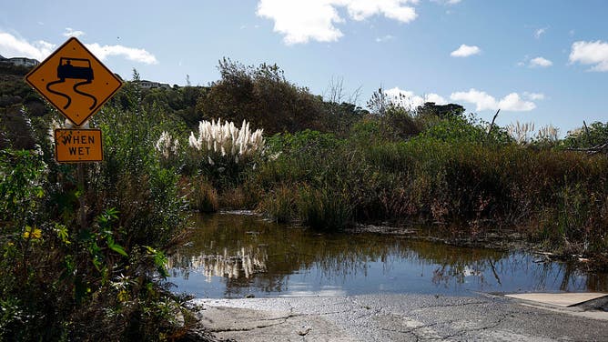 Floodwater from recent rains covers a roadway in Malibu, California, on October 22, 2026.