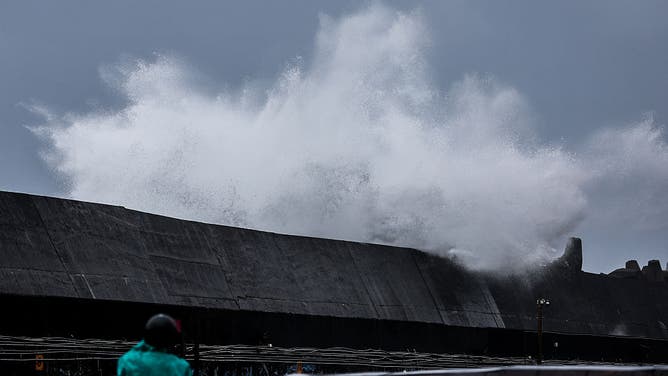 Waves crash against a breakwater as Typhoon Champi approaches Taiwan, in Keelung on October 23, 2026.