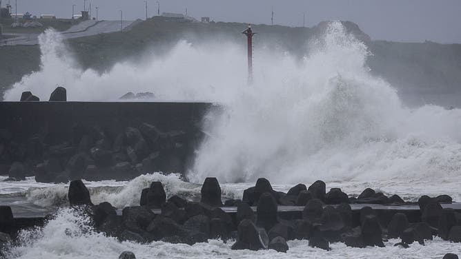Waves crash against concrete wave breakers along the coast as Typhoon Champi approaches Taiwan, in Keelung on October 23, 2026.