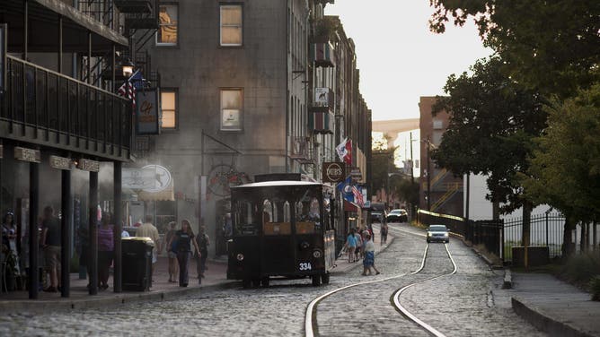 A trolley stops to pick up passengers on River Street in Savannah, Georgia, U.S., on Saturday, Aug. 15, 2015.