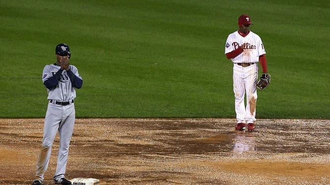 PHILADELPHIA - OCTOBER 27: Jimmy Rollins #11 (R) of the Philadelphia Phillies and B.J. Upton #2 of the Tampa Bay Rays stand on the rain soaked field during the top of the sixth innning during game five of the 2008 MLB World Series on October 27, 2008 at Citizens Bank Park in Philadelphia, Pennsylvania. 