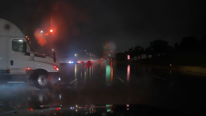 Nebraska driver narrowly avoids jackknifing semitruck on I-80 in Omaha amid pouring rain on Sep. 30, 2026.