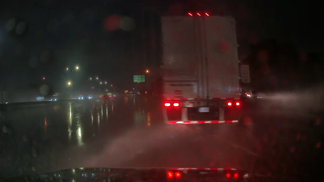 Nebraska driver narrowly avoids jackknifing semitruck on I-80 in Omaha amid pouring rain on Sep. 30, 2026.