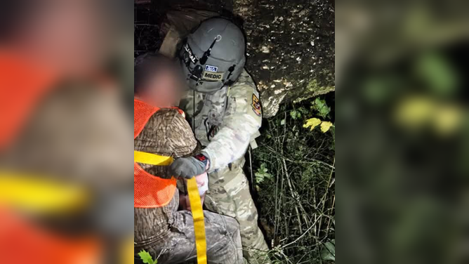U.S. Army Helicopter rescue team prepare the victim for a hoist operation.